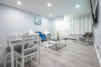 a living room with a table and a couch at Centre Street 2bed Upper Suite - 4408 in Calgary