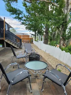 a group of chairs and tables on a patio at Centre Street 2bed Upper Suite - 4408 in Calgary