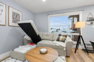 a living room with a couch and a table at Elegant Boho Retreat - 8 min to WEM in Edmonton