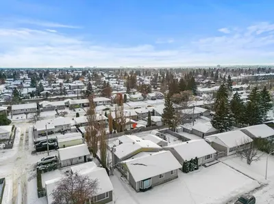 an aerial view of a parking lot with snow covered roofs at Elegant Boho Retreat - 8 min to WEM in Edmonton