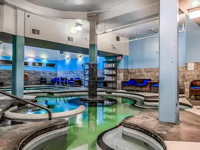 a large indoor swimming pool in a hotel room at Marvellous Mountain Condo- Pets - Pool & Hot Tub managed by Little Sister Getaways in Canmore