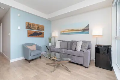 a living room with a couch and a glass table at A Gem In This Cityzen Hideaway in Victoria