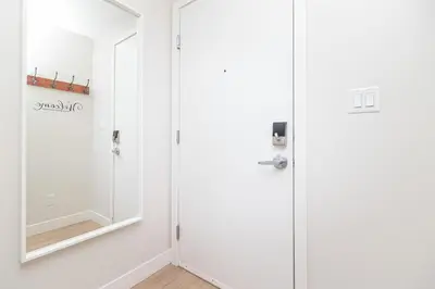 a bathroom with a mirror and a door at A Gem In This Cityzen Hideaway in Victoria