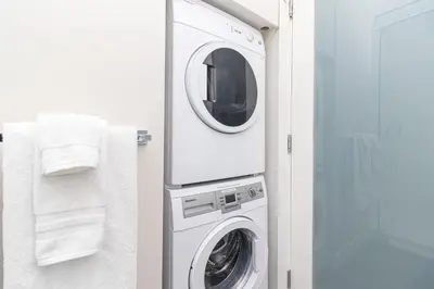 a white washer and dryer in a bathroom at A Gem In This Cityzen Hideaway in Victoria