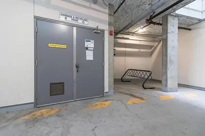 a large metal door in a room with a bench at A Gem In This Cityzen Hideaway in Victoria