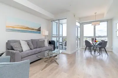 a living room with a couch and a table with chairs at A Gem In This Cityzen Hideaway in Victoria