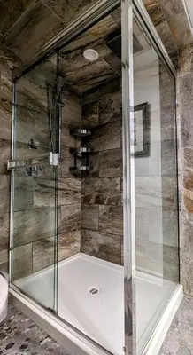 a shower with a glass enclosure in a bathroom at By the Sea in Campbell River