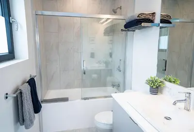 a bathroom with a shower and a toilet and a sink at Summit Views Condo by Revelstoke Vacations in Revelstoke