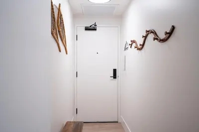 a white door in a room with a wall at Summit Views Condo by Revelstoke Vacations in Revelstoke