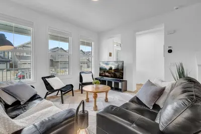 a living room with two leather couches and a tv at LovelyHome-Foosball-NearAirport-5 Queen Beds -Air conditioning in Edmonton