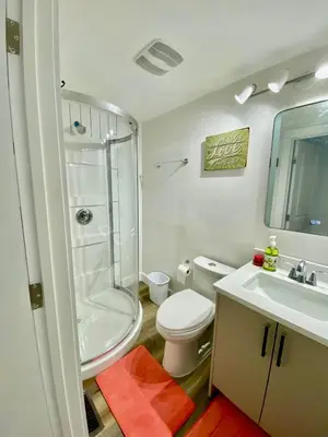 a bathroom with a shower and a toilet and a sink at Farmstay in Edmonton in Duffield