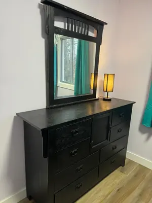a dresser with a mirror and a lamp on it at Farmstay in Edmonton in Duffield