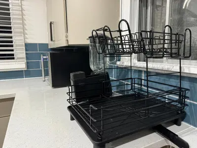 a black metal object sitting on a table in a kitchen at Farmstay in Edmonton in Duffield