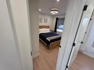 a small bedroom with a bed and a window at Premium Deluxe PeachView Suites 3BR in Peachland