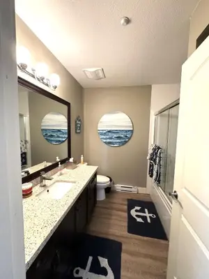 a bathroom with two sinks and a large mirror at White Rock Beach getaway in White Rock