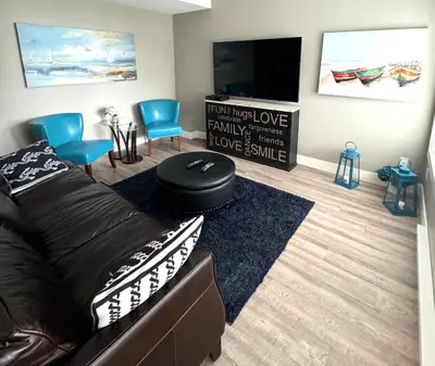 a living room with a couch and a flat screen tv at White Rock Beach getaway in White Rock