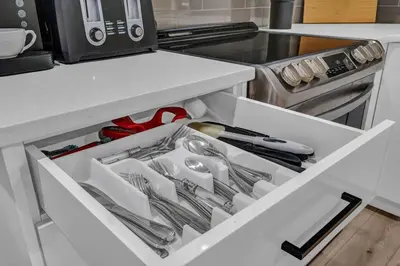 a white drawer in a kitchen with utensils at ModernSuite*NearAirport*2Queens*2Bedroom*FullKitchen in Edmonton