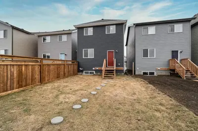 a backyard with a fence and some houses at ModernSuite*NearAirport*2Queens*2Bedroom*FullKitchen in Edmonton