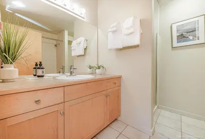 a bathroom with a sink and a mirror at Lovely Mountain View 2 Bedroom Suite in Canmore