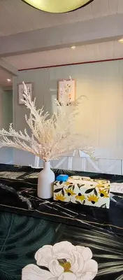 a room with a vase with flowers on a table at White House Tofino Downtown Villa in Tofino