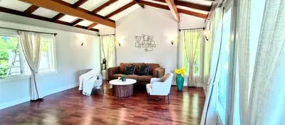 a living room with a couch and a table at White House Tofino Downtown Villa in Tofino