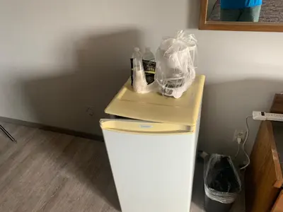 a table on top of a refrigerator in a room at Wild Rose Inn in Vegreville
