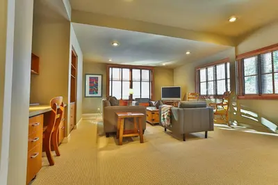 a living room with a couch and a table at 4 Mt Brewer by StayIn in Panorama