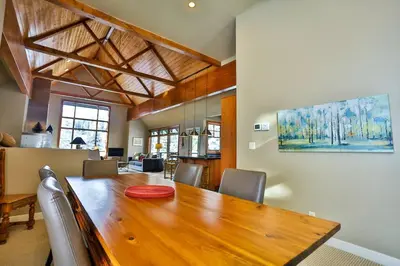 a dining room with a wooden table and chairs at 4 Mt Brewer by StayIn in Panorama