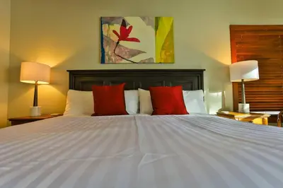 a bedroom with a white bed with red pillows at 4 Mt Brewer by StayIn in Panorama