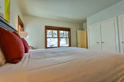 a large bed in a room with a window at 4 Mt Brewer by StayIn in Panorama