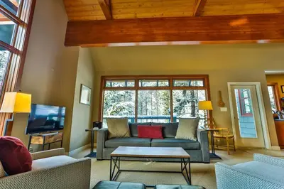 a living room with a couch and a tv at 4 Mt Brewer by StayIn in Panorama