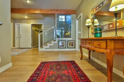 a living room with a wooden table and a red rug at 4 Mt Brewer by StayIn in Panorama