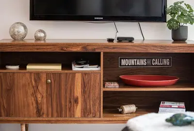 a television on top of a wooden entertainment center at Tucker's Place in Revelstoke