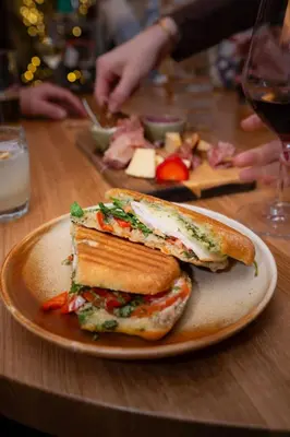 a sandwich on a plate on a table at Gravity Haus Revelstoke in Revelstoke
