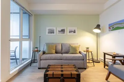 a living room with a couch and a table at Be The Perfect Cityzen In Cityzen in Victoria