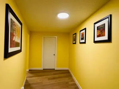 a hallway with yellow walls and a white door at Avola Mountain Lodge in Avola