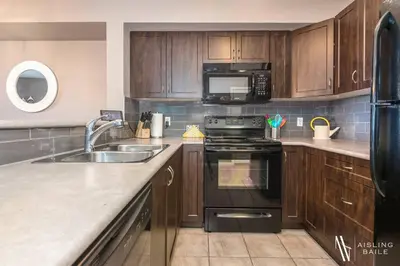 a kitchen with a sink and a stove top oven at Contemporary, Cozy, Pool, Hot Tub, Lake Front in Invermere