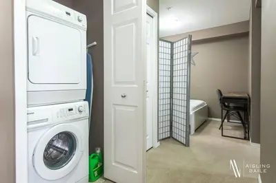 a laundry room with a washer and dryer in a house at Contemporary, Cozy, Pool, Hot Tub, Lake Front in Invermere