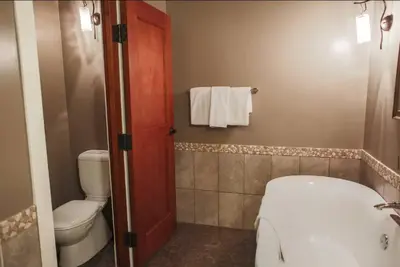 a bathroom with a toilet and a sink at Magnificent Mountain Penthouse - Hot Tub & Pool managed by Little Sister Getaways in Canmore