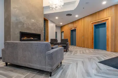 a living room with a fireplace and furniture at Studio in Alpenglow Lodge, Private Balcony with Mountain Views, Gym, Epic Location in Whistler
