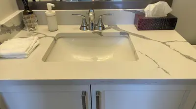 a sink in a bathroom with a counter at Home In Vancouver in Richmond