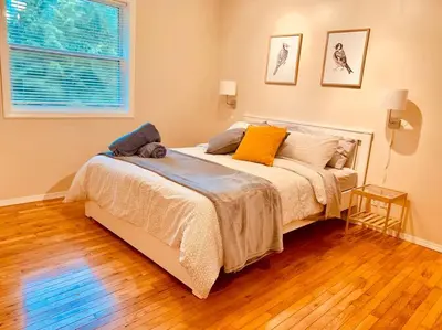 a bedroom with a bed with two pillows on it at Blue Cedar Suite in Tofino