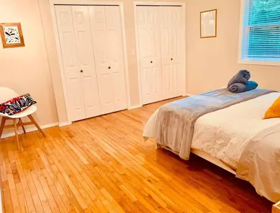 a bedroom with a teddy bear sitting on a bed at Blue Cedar Suite in Tofino