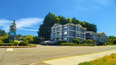 a large blue apartment building on a street at Gibsons Landing Inn in Gibsons