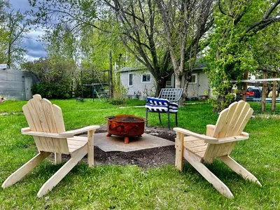 two chairs and a fire pit in a yard at Farmhouse in Alberta in Duffield