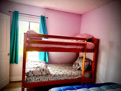 two bunk beds in a room with pink walls at Farmhouse in Alberta in Duffield