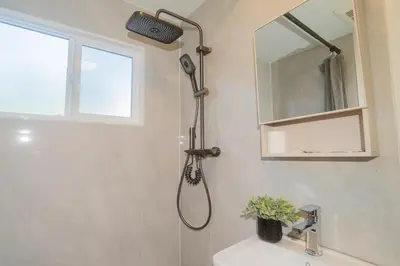 a shower in a bathroom with a shower head at InnTowne Motel II in Hope
