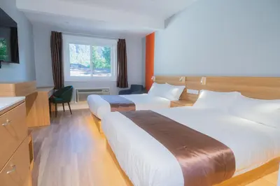a hotel room with two beds and a window at InnTowne Motel II in Hope