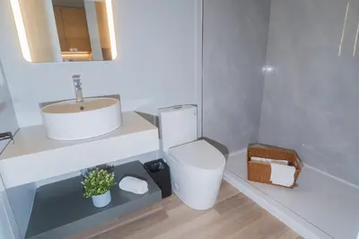 a white bathroom with a sink and a toilet at InnTowne Motel II in Hope