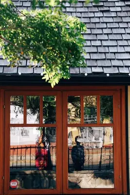 a window of a building with reflections in it at Fort Langley Homestead in Maple Ridge District Municipality